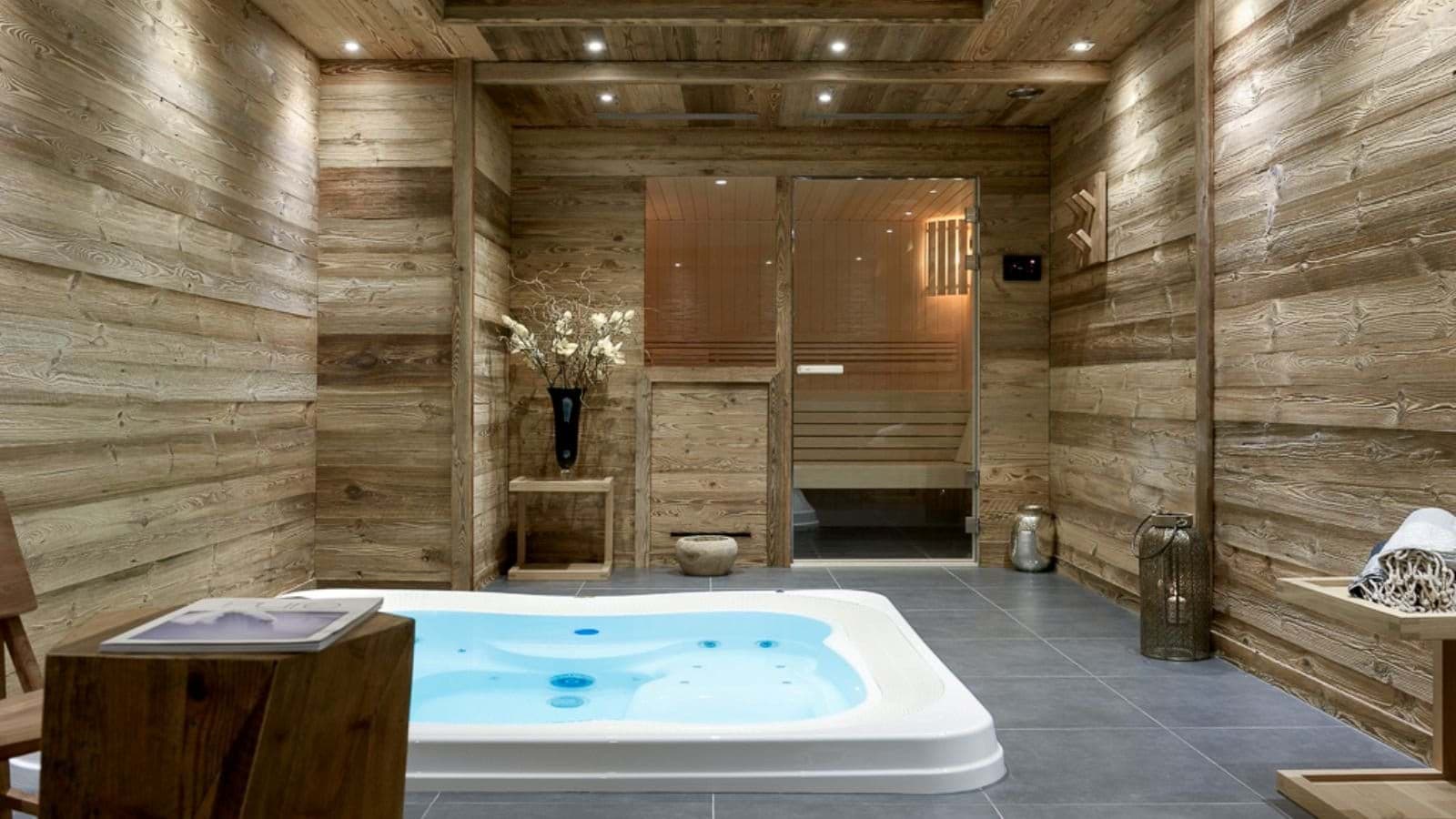 Private spa room featuring an indoor hot tub and glass-fronted sauna