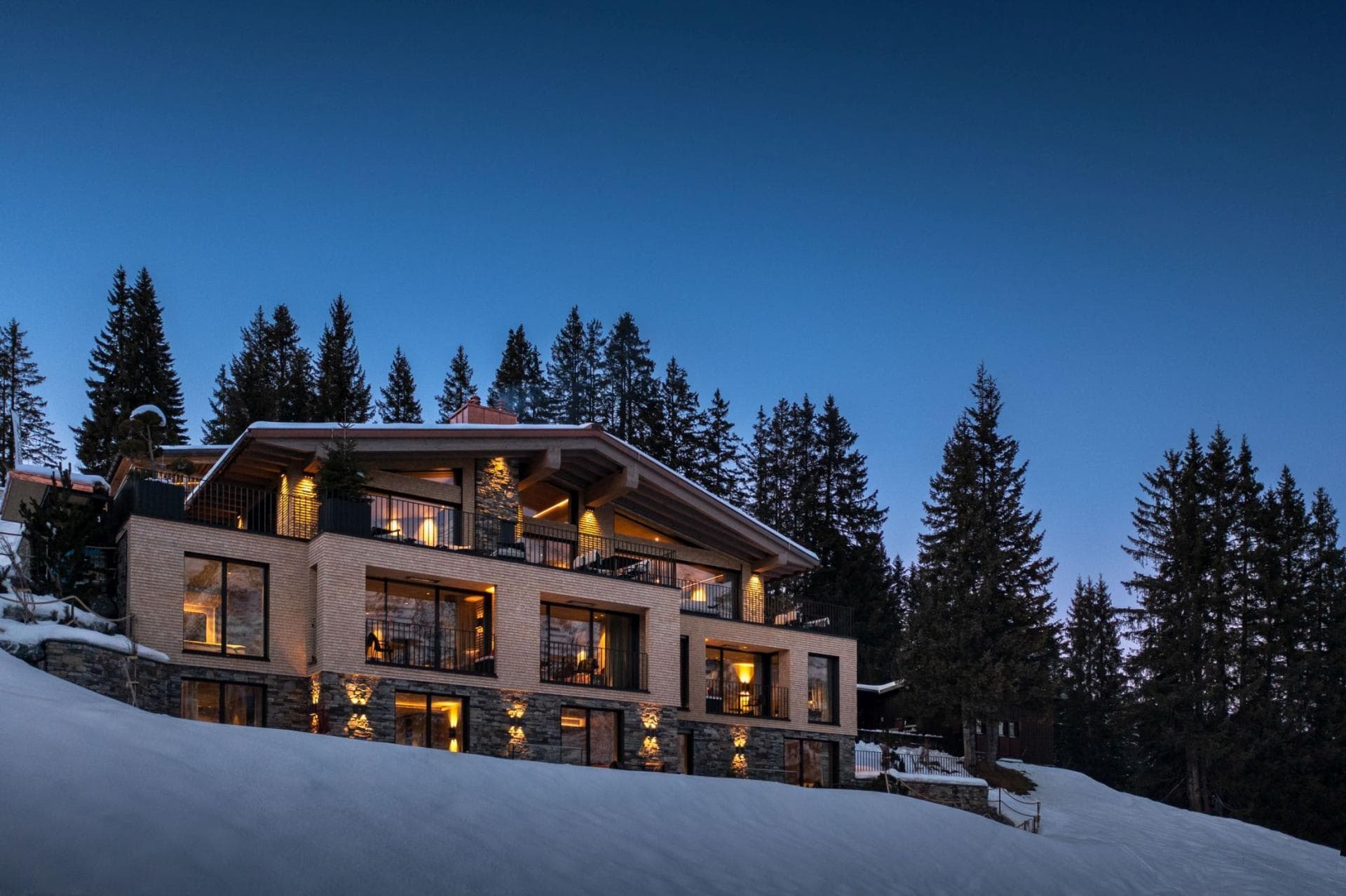 Chalet exterior with multiple balconies and direct ski slope access