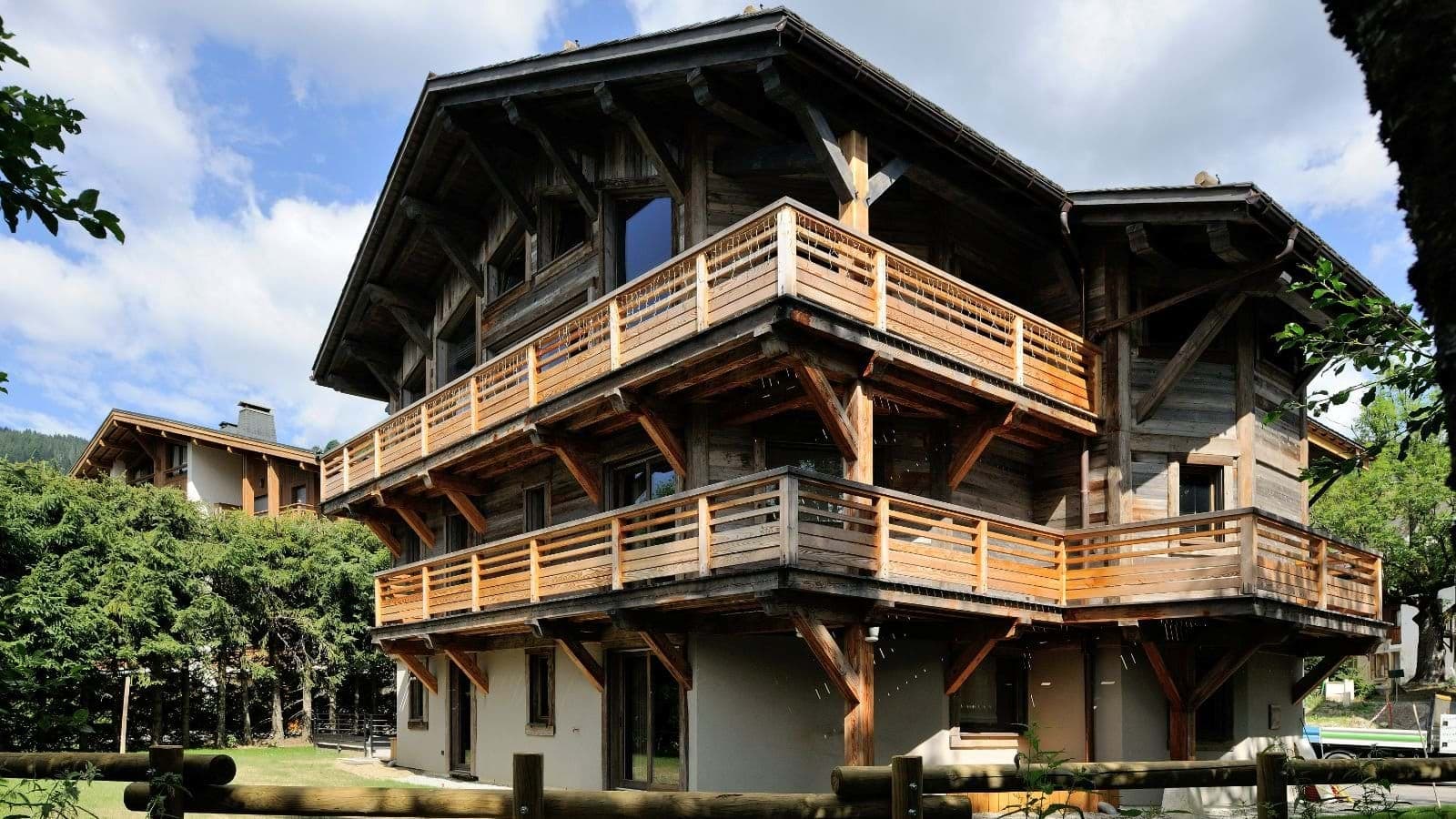 Chalet exterior with three levels of wrap-around timber balconies