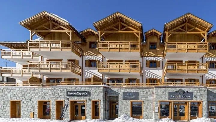 Ski chalet exterior with private balconies and ground-floor ski shop access