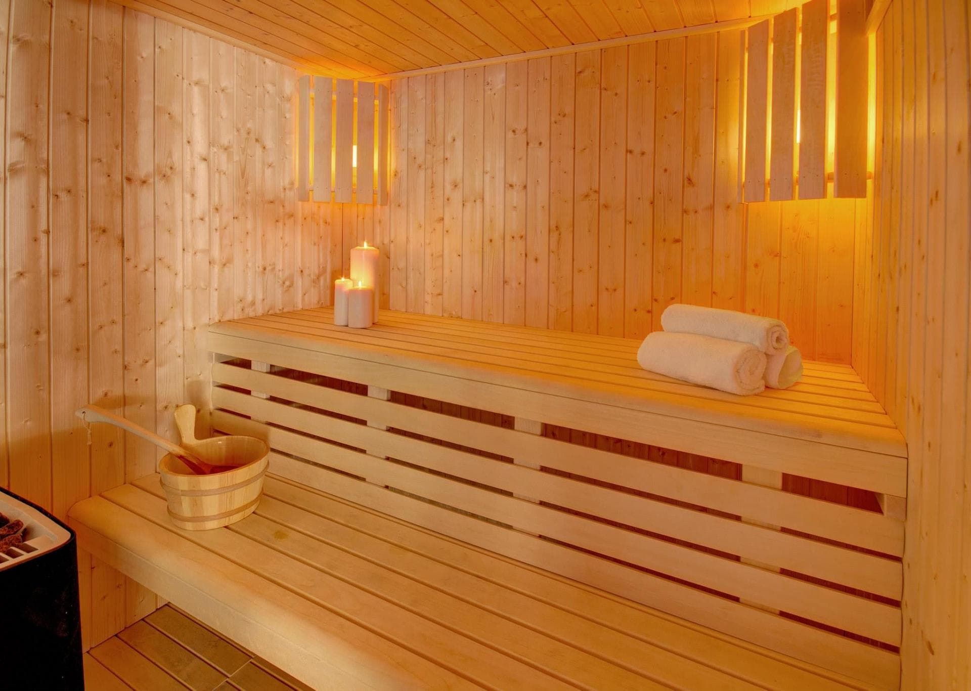 Private cedar sauna with two-tier seating and ambient lighting