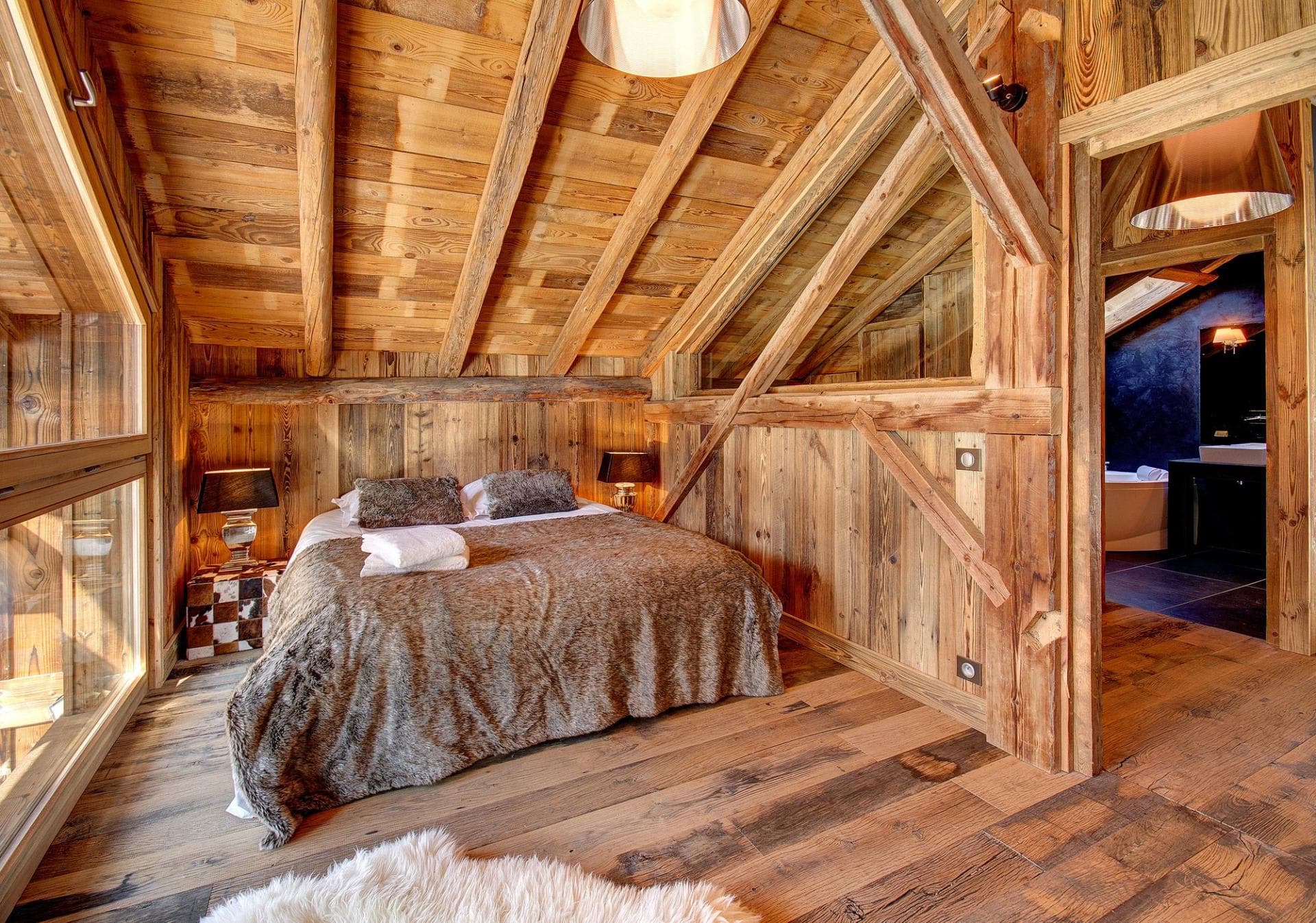 Loft bedroom with queen bed and ensuite bathroom featuring soaking tub