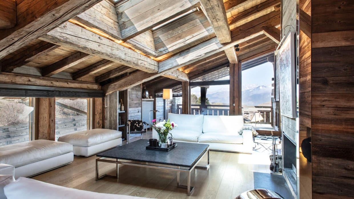Living room with skylights, timber beams, and mountain views