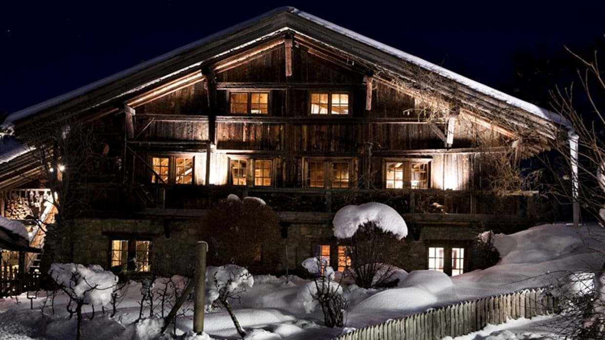 Timber and stone chalet exterior with wraparound balcony
