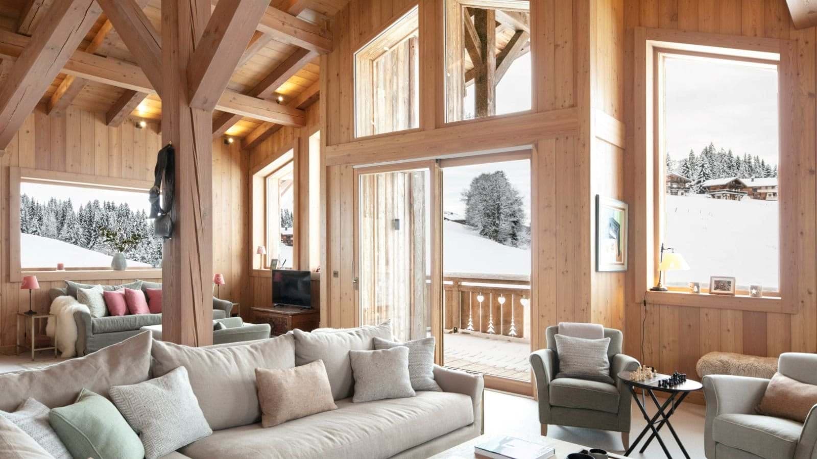 Living area with vaulted timber ceilings and views of the ski slopes
