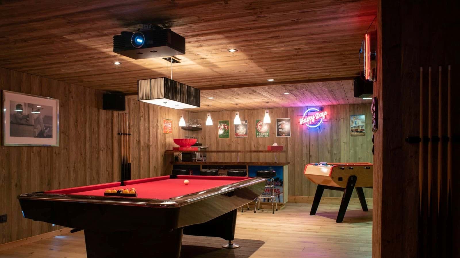 Game room with pool table, foosball, wet bar, and overhead projector