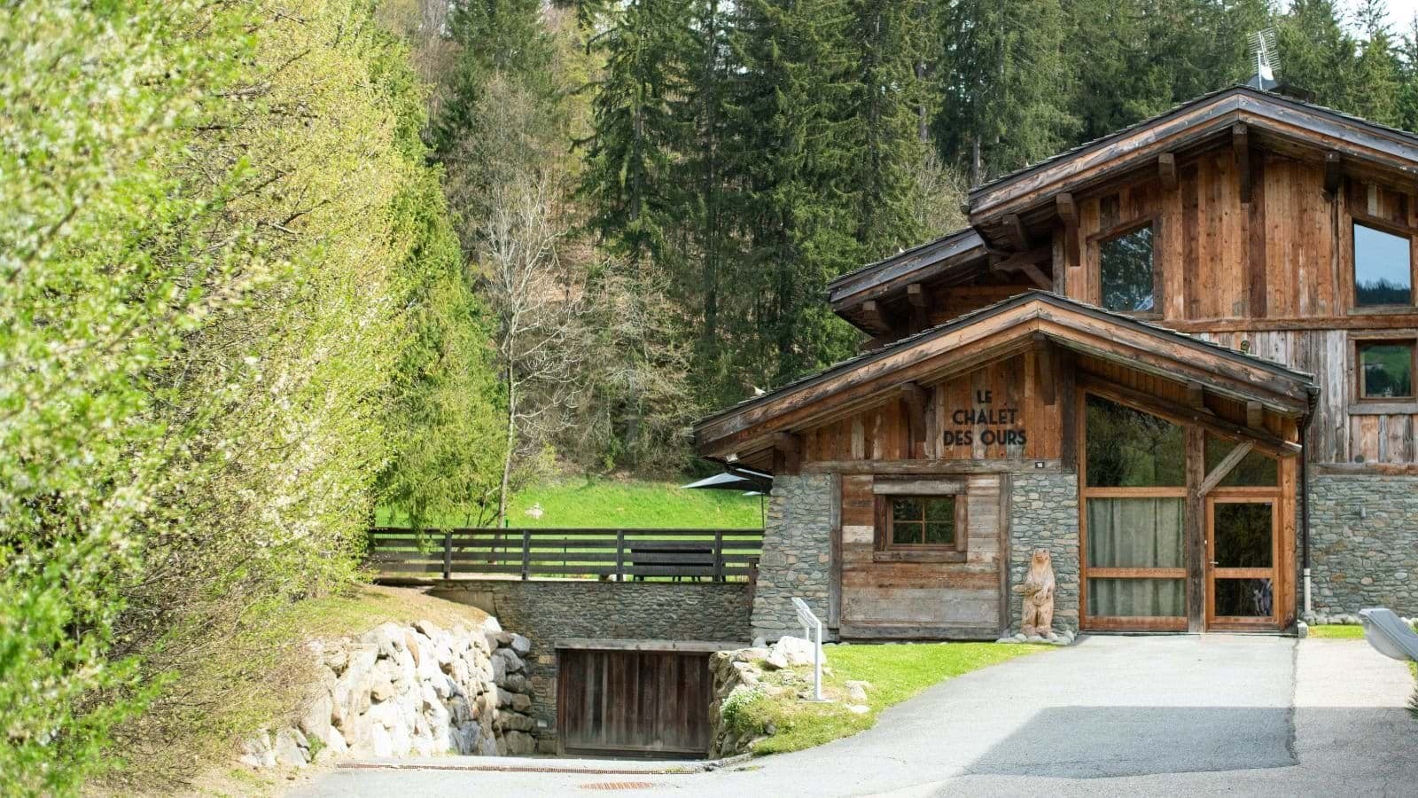 Chalet entrance featuring private driveway and underground garage parking