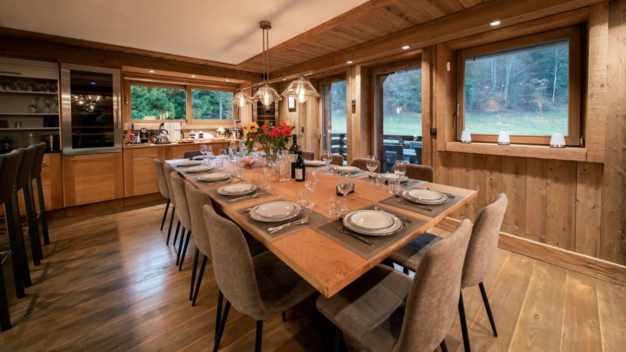 Dining area with seating for 12; built-in wine fridge and forest views