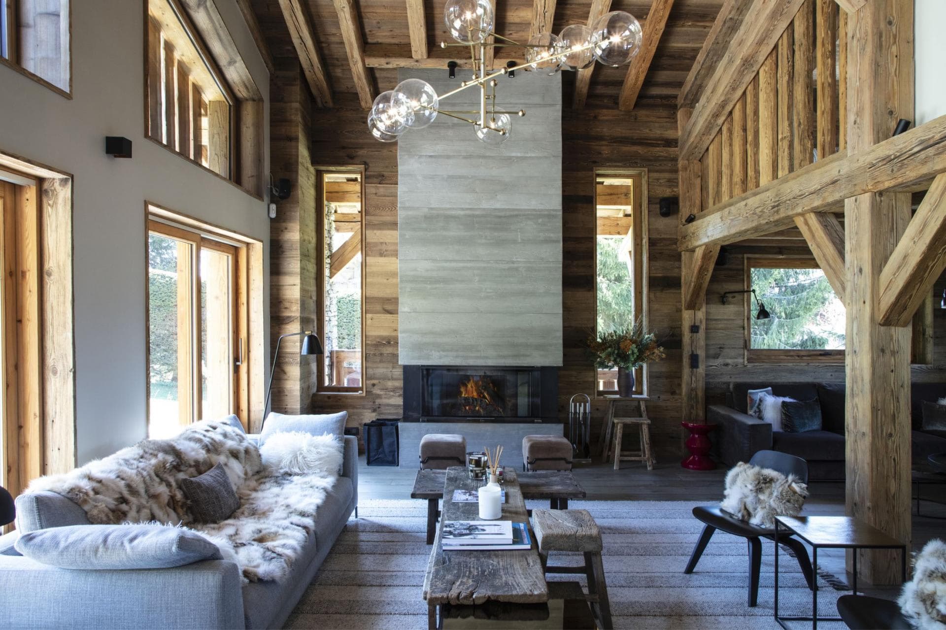 Double-height living room with wood-burning fireplace and exposed timber beams