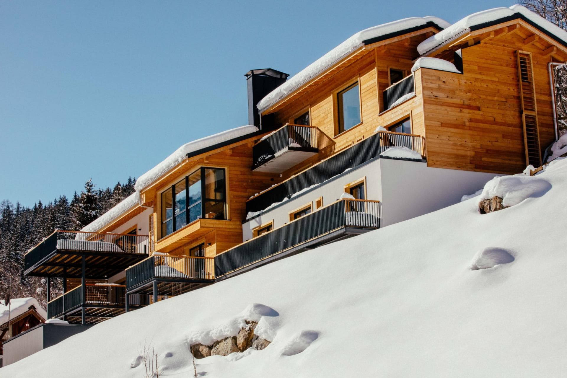 Ski-in/ski-out chalet with multiple private balconies and floor-to-ceiling windows