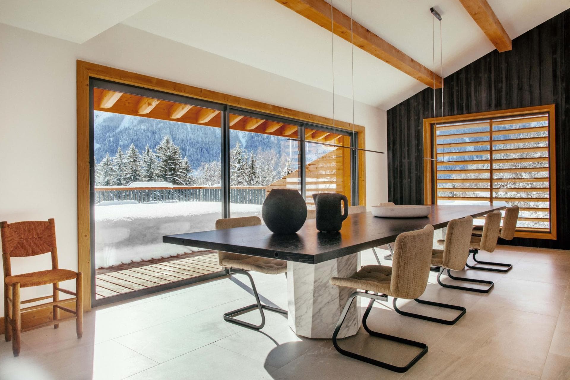 Dining area with seating for 8 and floor-to-ceiling mountain views