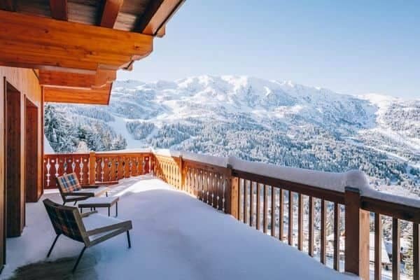 Private balcony with lounge seating and panoramic ski slope views