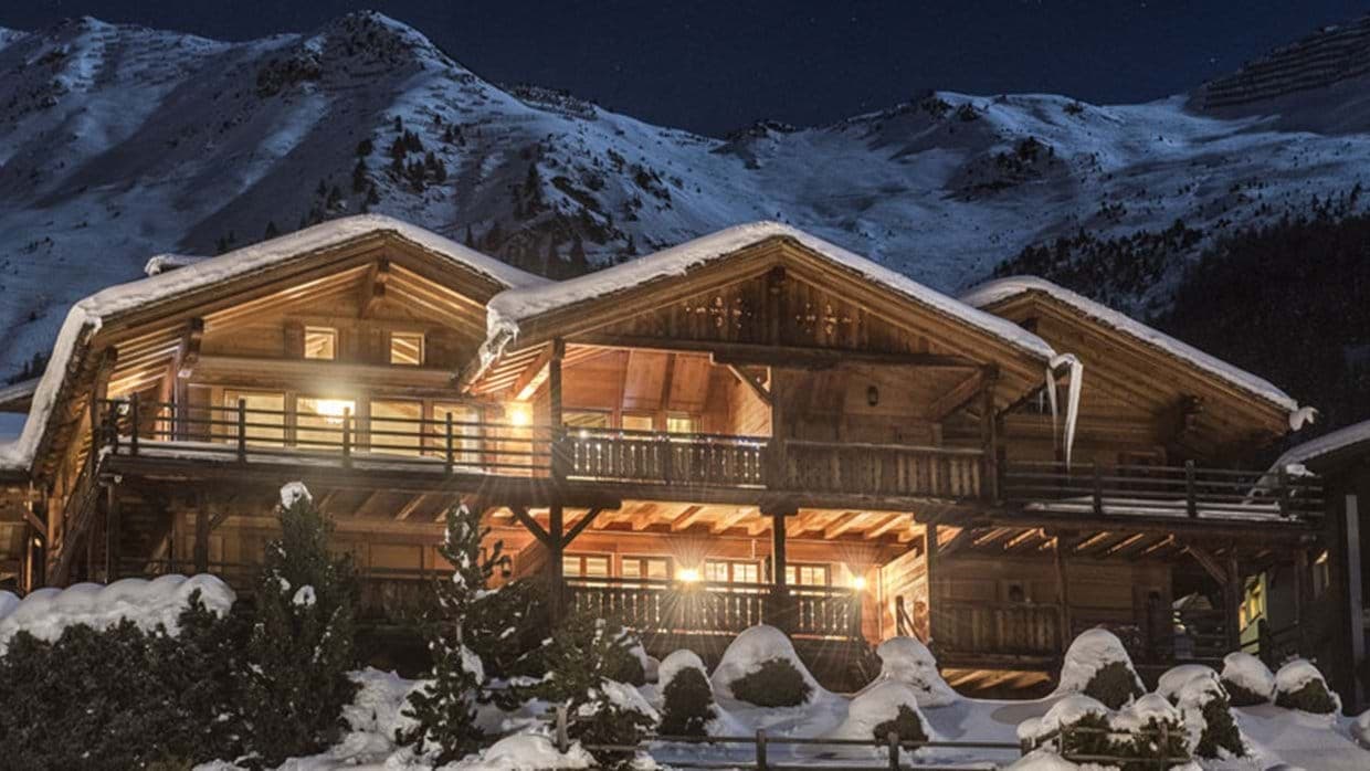 Multi-level timber chalet featuring wraparound balconies and mountain views