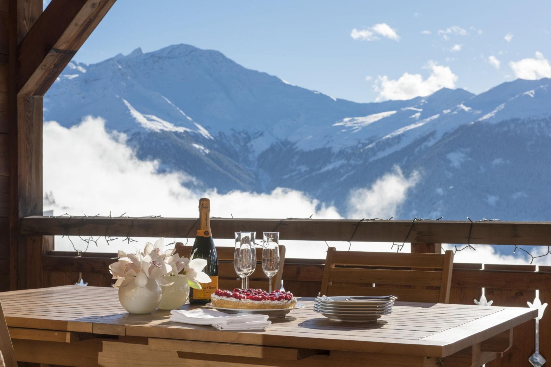 Covered balcony dining area with panoramic alpine views