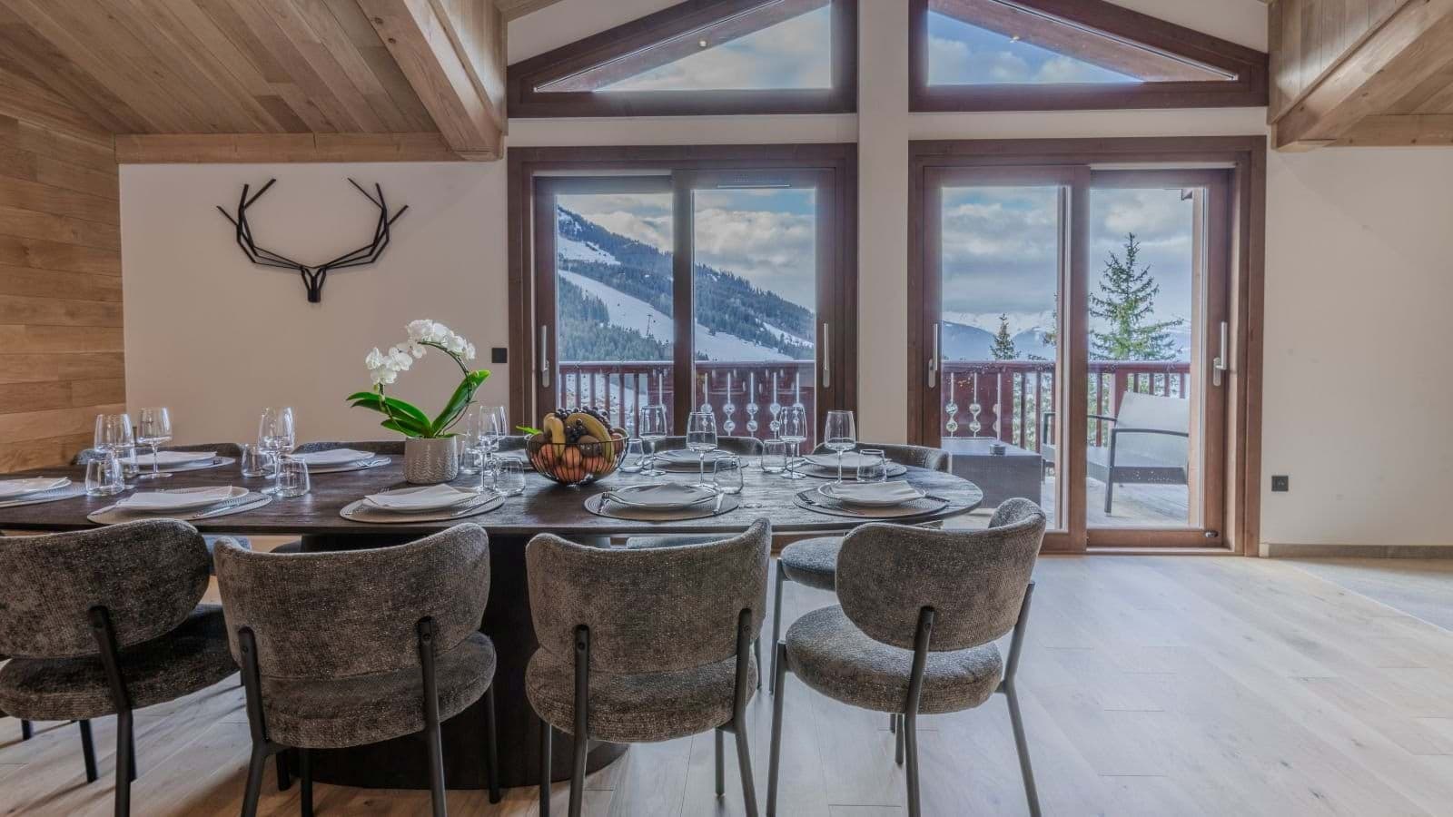 Dining area with seating for 10 and balcony access to mountain views