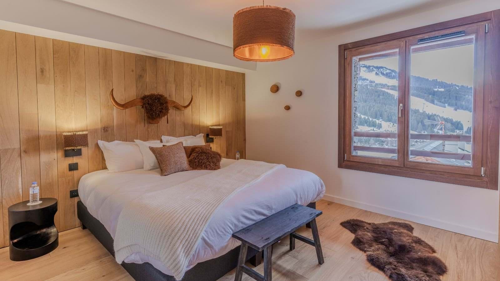 Primary bedroom with king bed and ski slope views