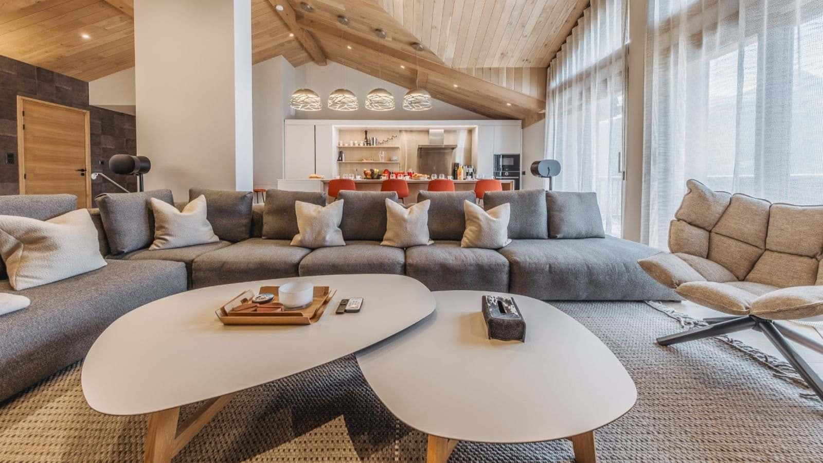 Open living area with vaulted wood ceilings and sectional seating for 8