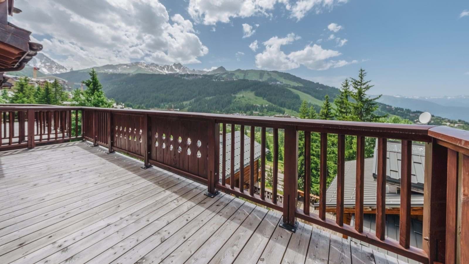 Private balcony with wooden decking and panoramic mountain views