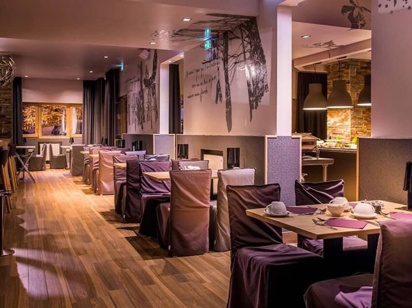 Dining area with breakfast buffet and high-back chair seating