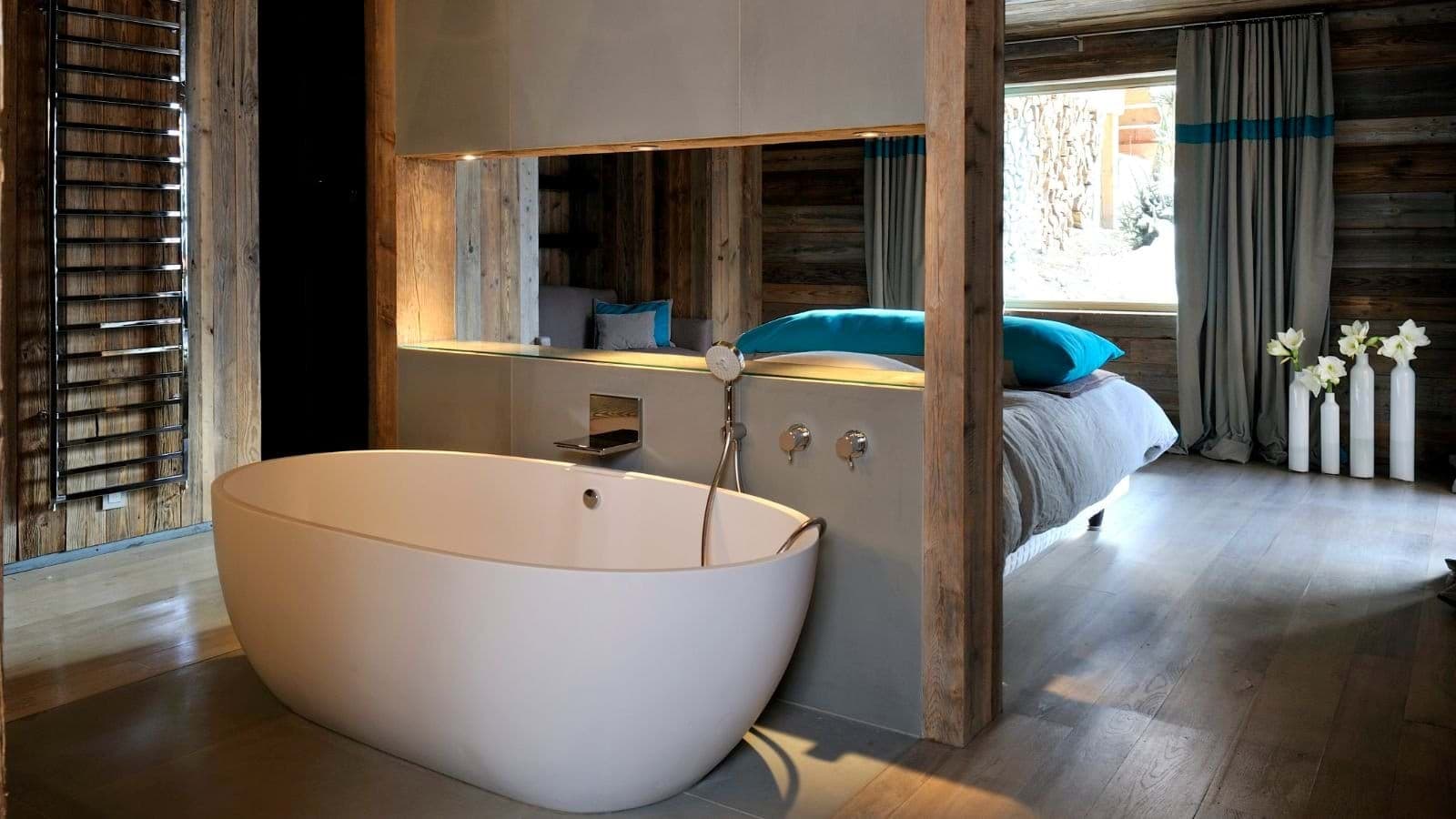 Open-concept suite with soaking tub and heated towel rail