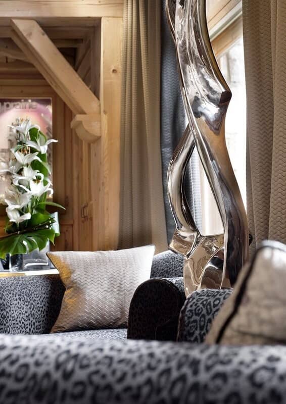 Living room seating with leopard print upholstery and exposed timber beams