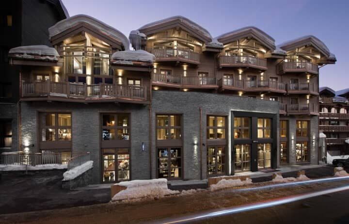 Ski-in/ski-out lodge facade with private balconies and heated gear storage