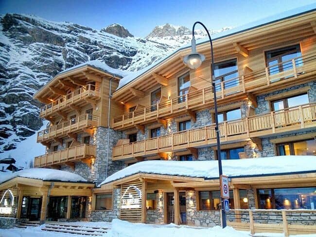 Ski-in/ski-out chalet exterior with private balconies and mountain backdrop