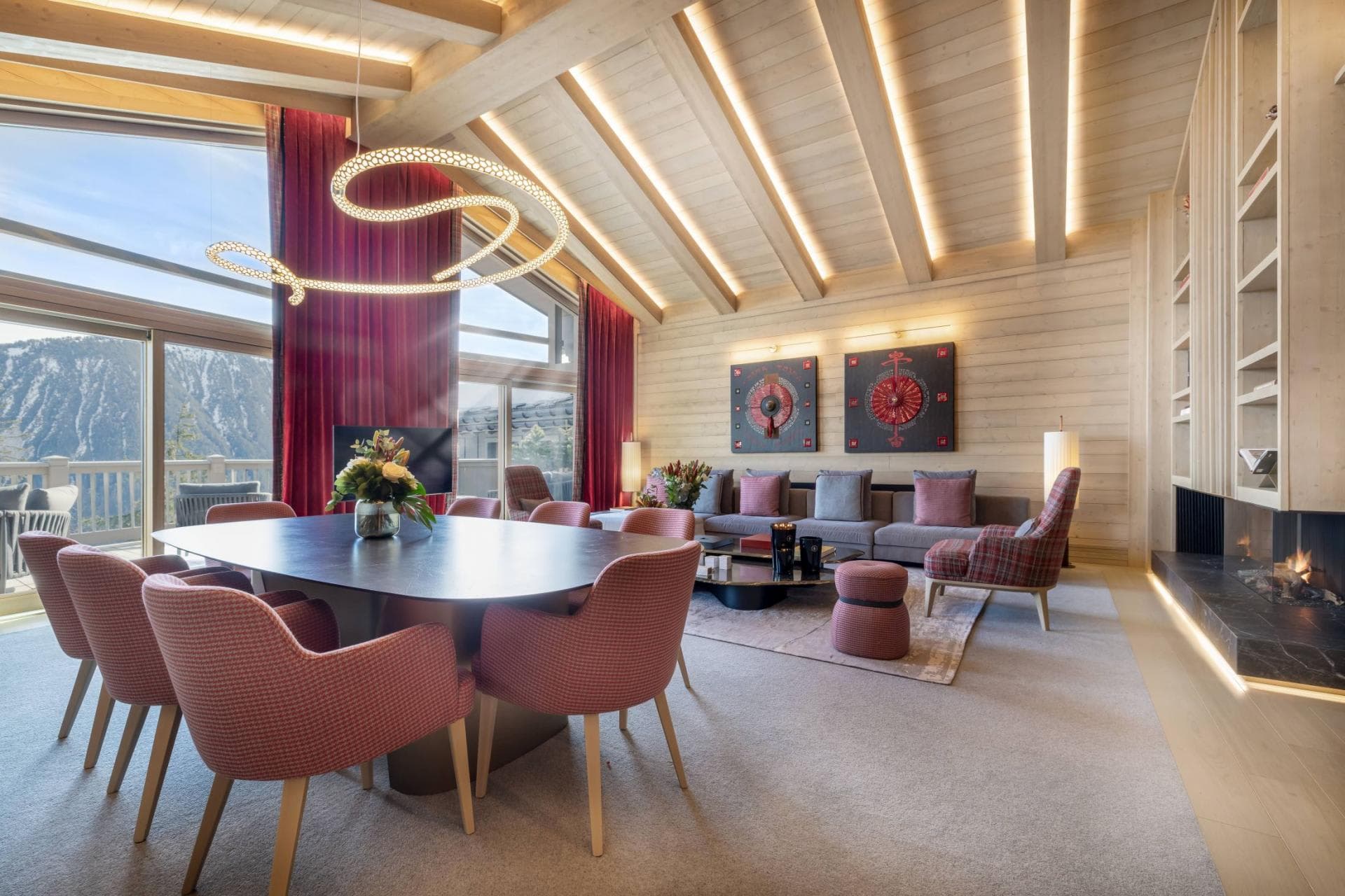 Open-plan living area with vaulted ceilings, gas fireplace, and mountain views