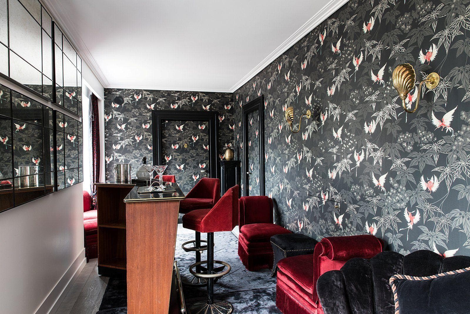 Private cocktail bar with velvet seating and bird-motif wallpaper