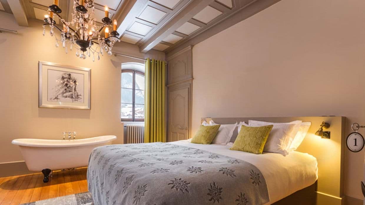 Bedroom with king bed and in-room clawfoot soaking tub