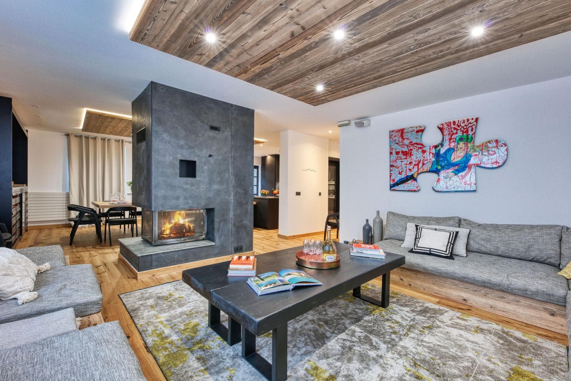 Living area with wood ceilings and central dual-sided fireplace