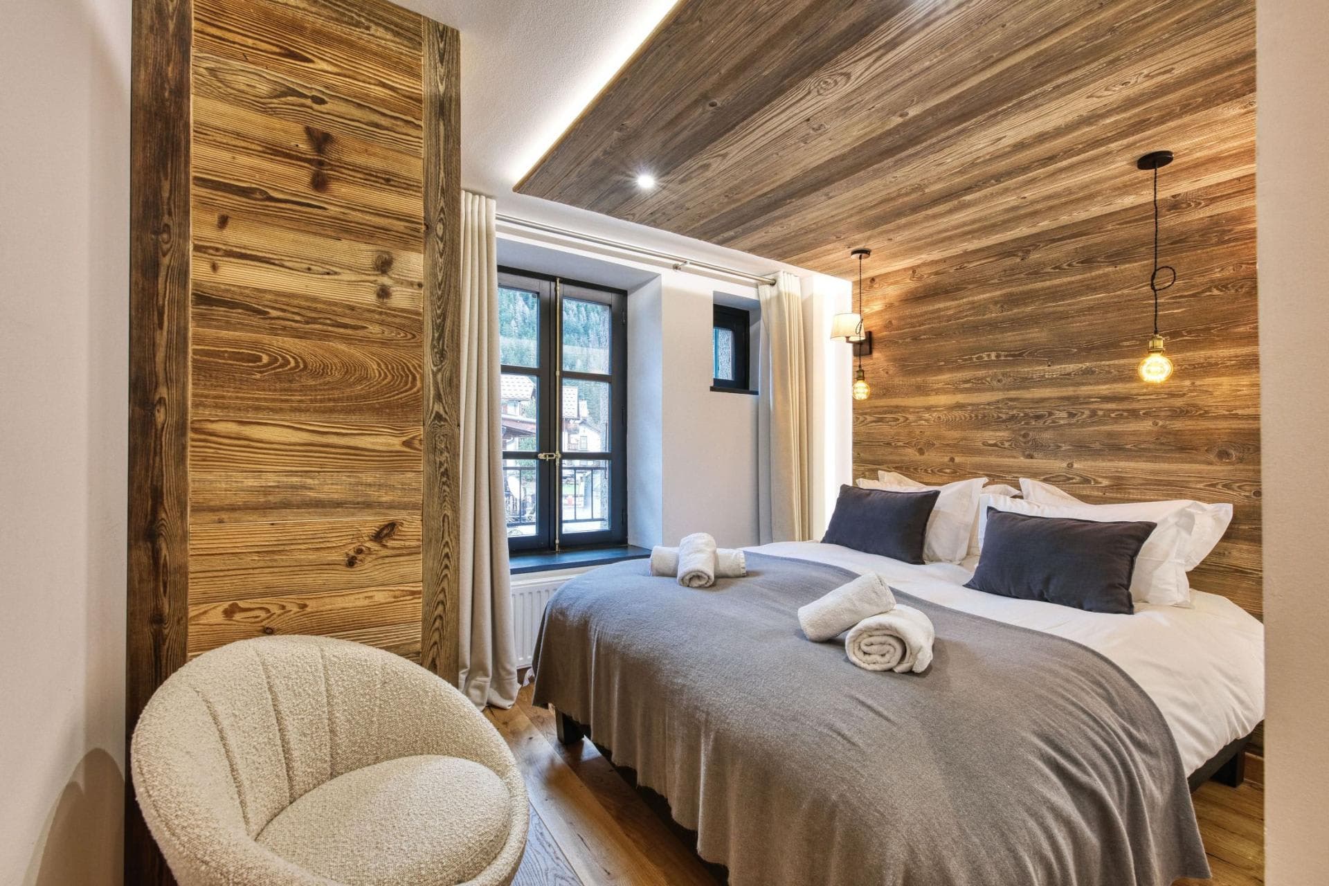Bedroom with king bed and reclaimed wood walls