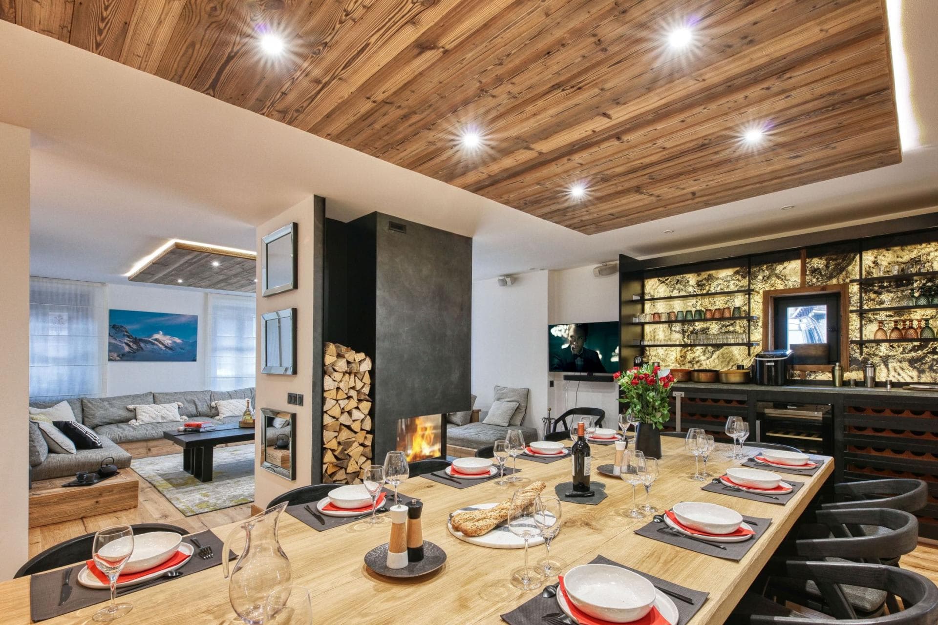 Dining area seats 10 with two-sided fireplace and integrated wine bar