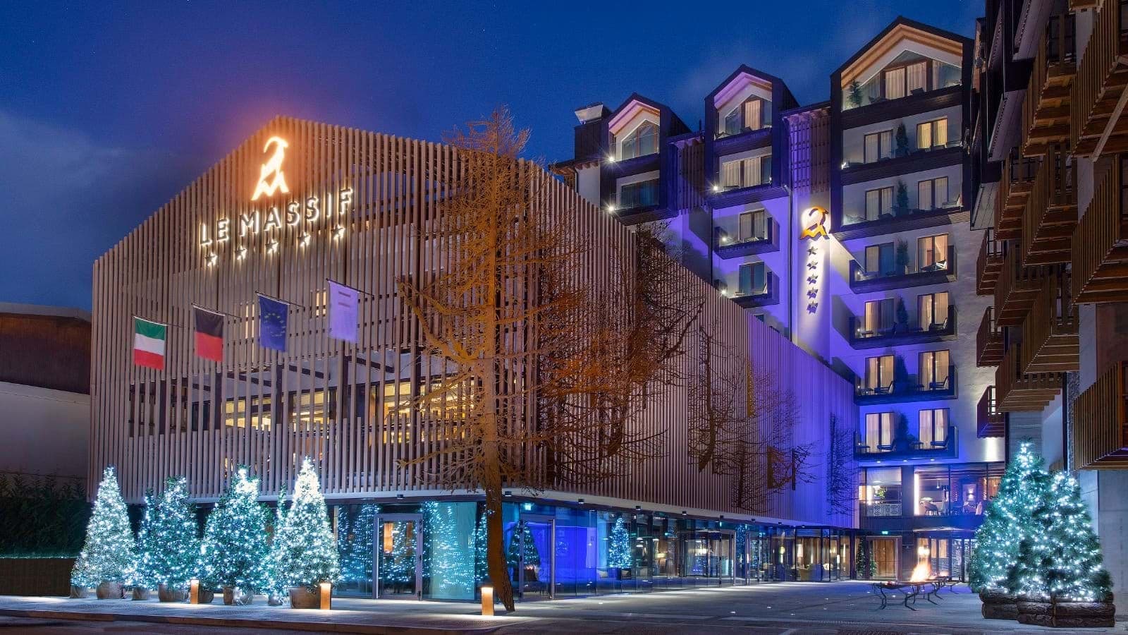 Hotel exterior with private balconies and ground-level fire pit area