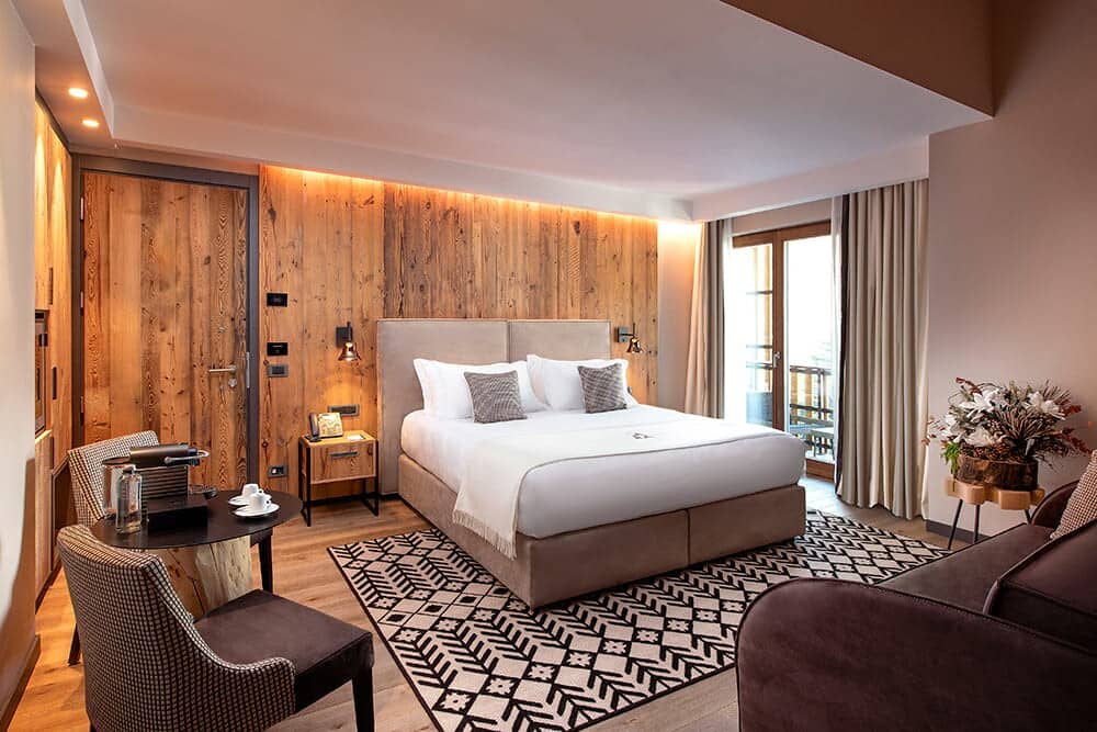 Primary bedroom with king bed, Nespresso station, and private balcony access