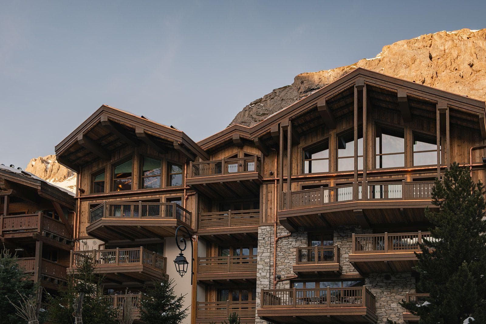 Chalet exterior with multiple private balconies and copper downspouts