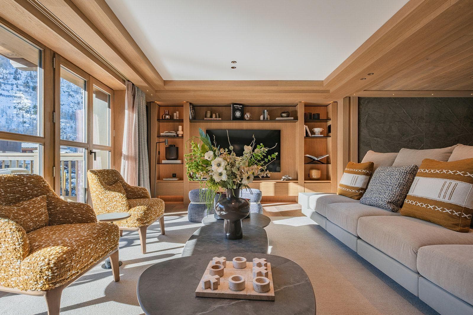 Living area with floor-to-ceiling windows and mountain views