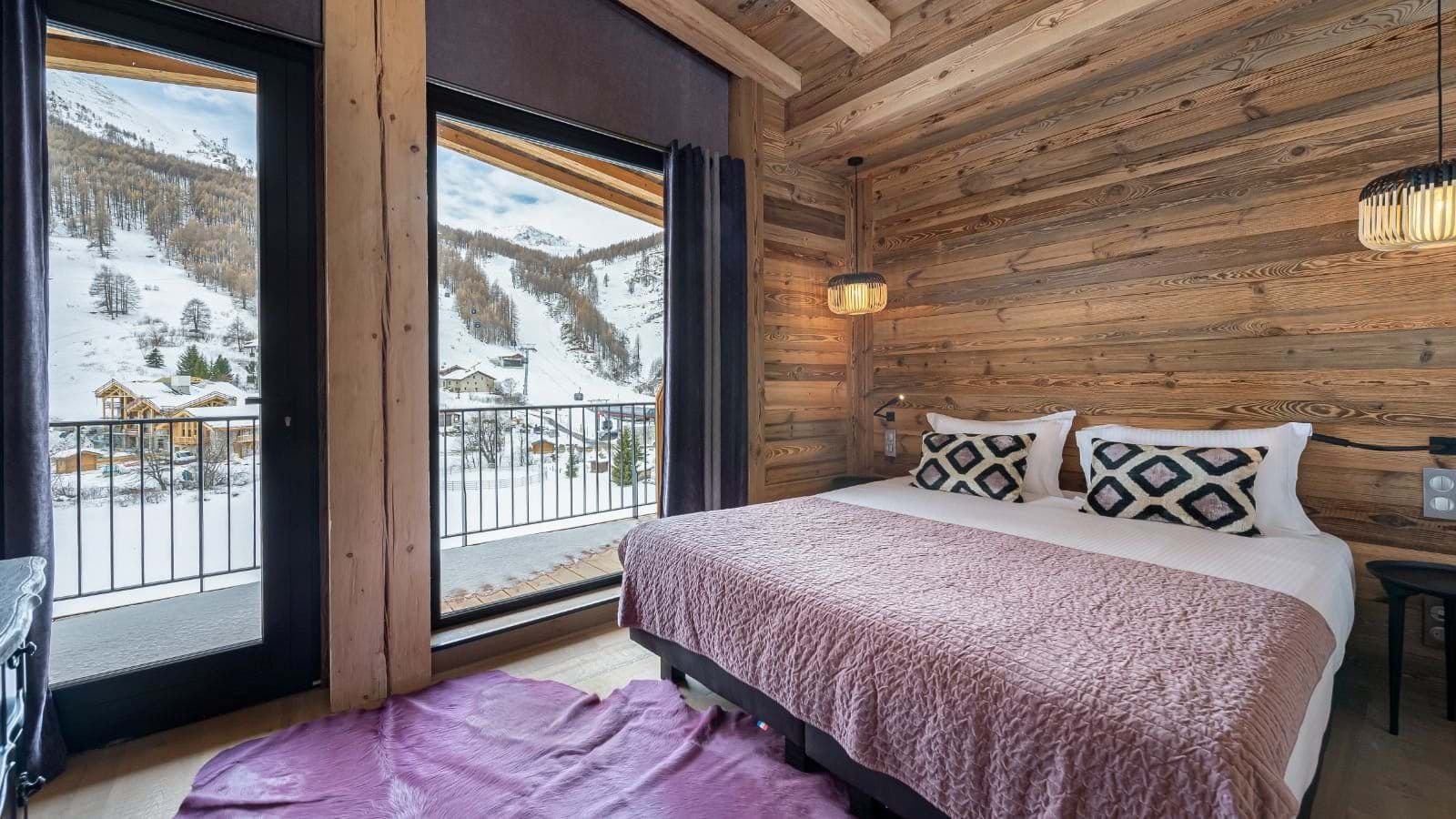Bedroom with king bed and balcony access to mountain views