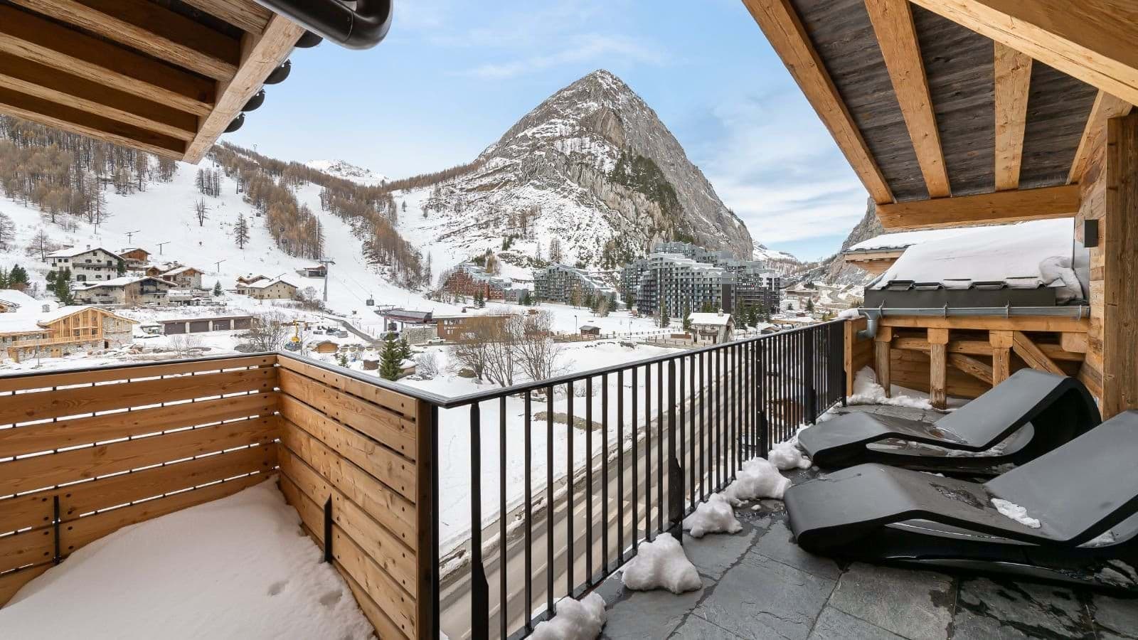 Private balcony with lounge seating and views of ski lifts
