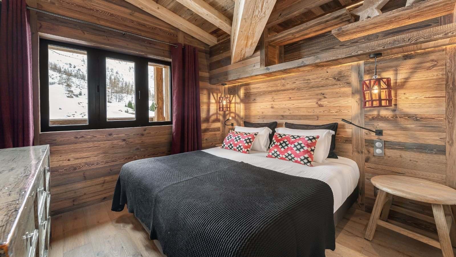 Guest bedroom with queen bed and mountain views
