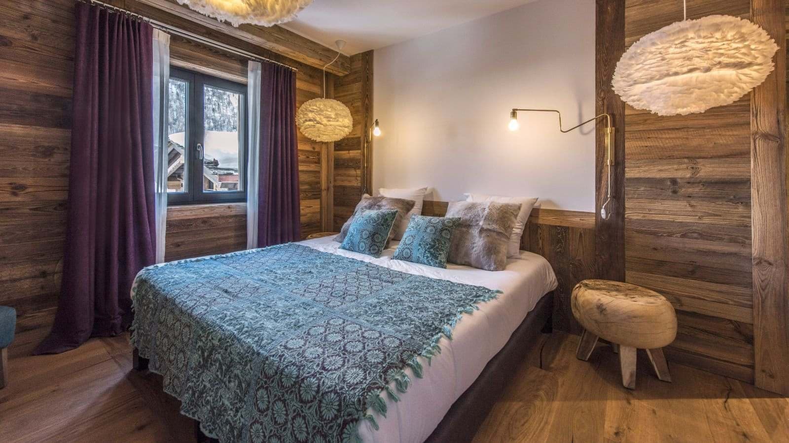 Guest bedroom with king bed and reclaimed wood paneling