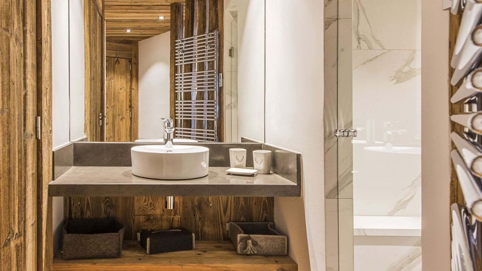 Bathroom with vessel sink and heated towel rail