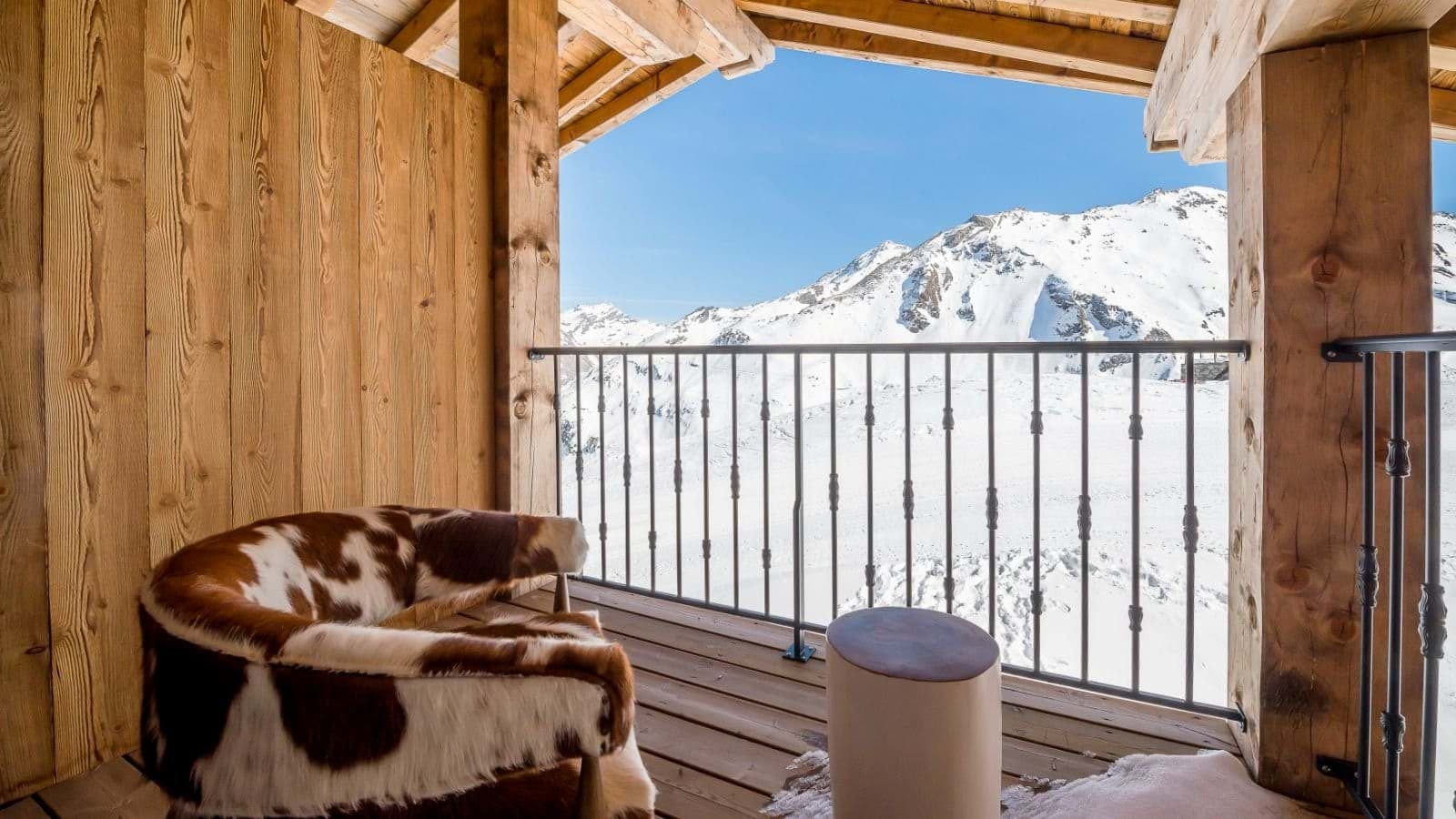 Private balcony with cowhide armchair and mountain views