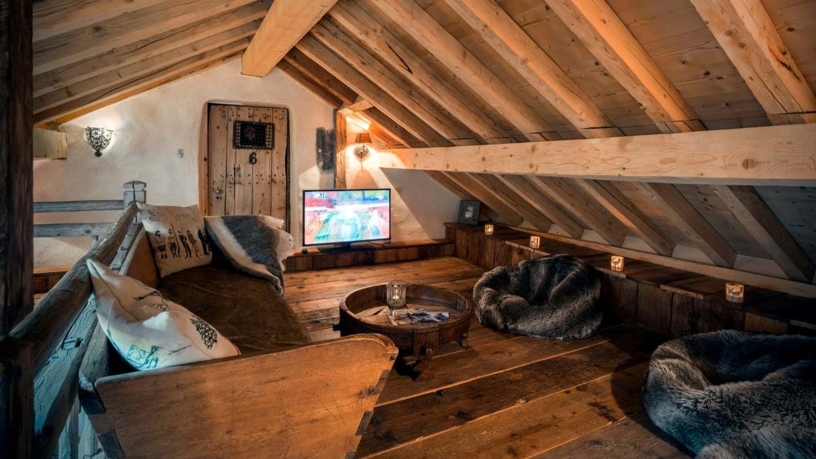 Loft media room with flat-screen TV and bean bag seating