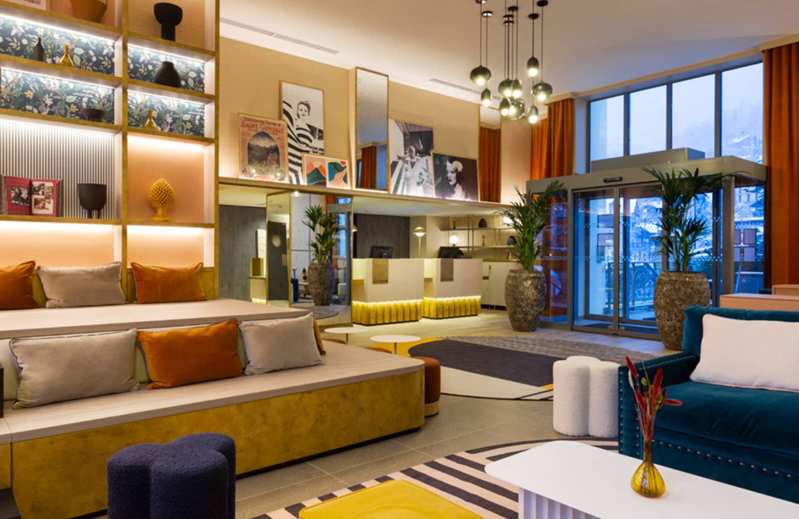 Lobby entrance with tiered banquette seating and 24-hour reception desks