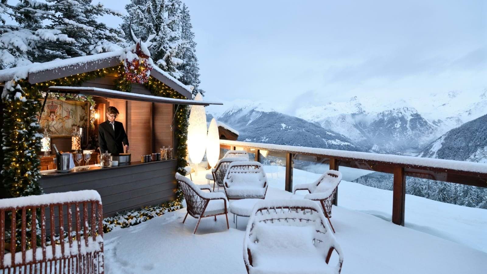 Private outdoor terrace bar with mountain views and lounge seating