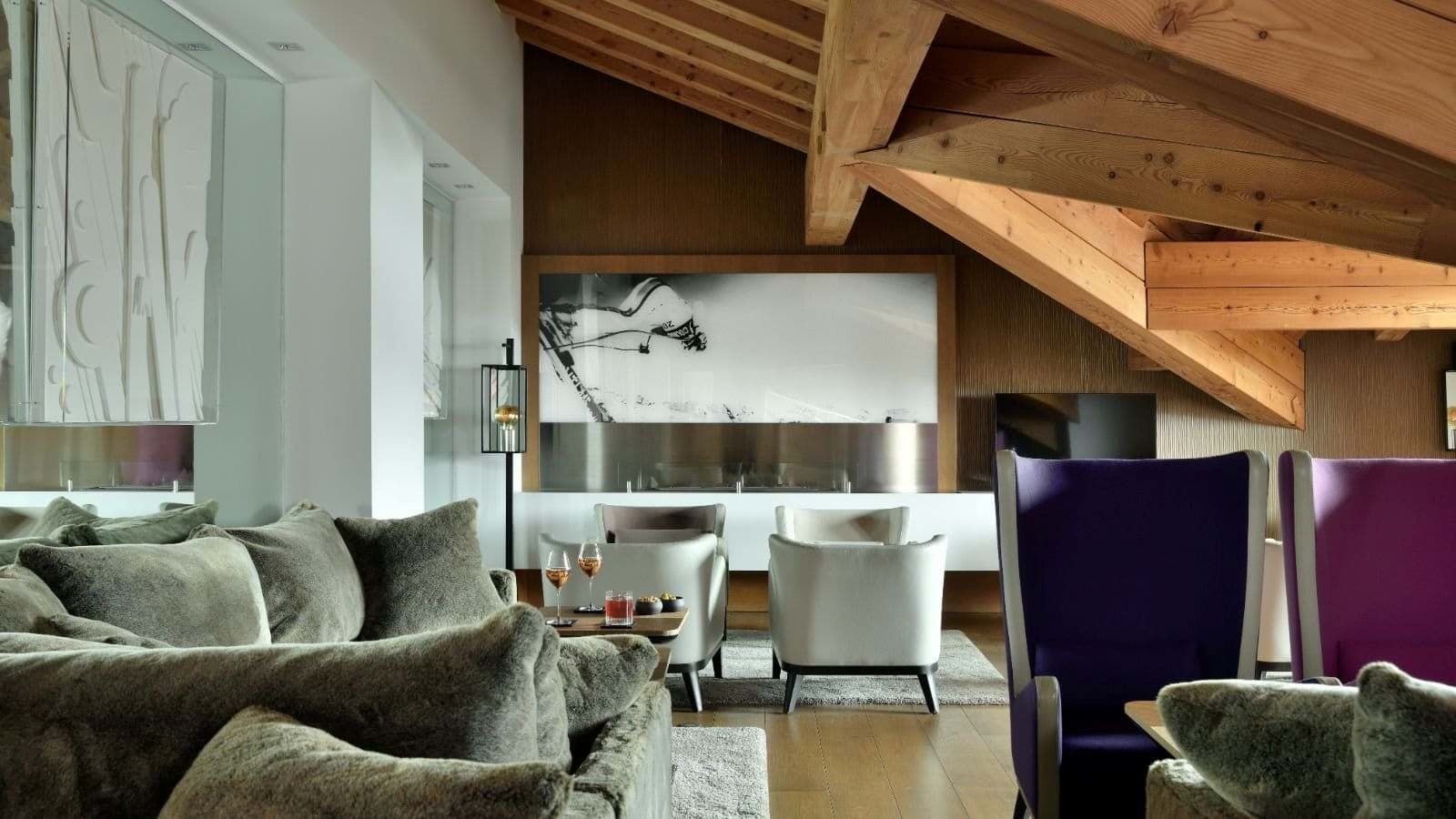 Lounge area with linear gas fireplace and vaulted timber ceilings