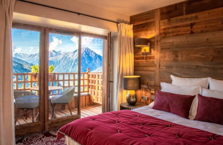 Bedroom with king bed and private balcony overlooking the mountains