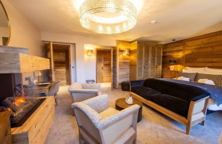 Primary bedroom with electric fireplace and private seating area