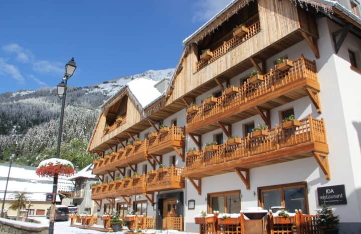 Chalet exterior featuring private wooden balconies and on-site restaurant
